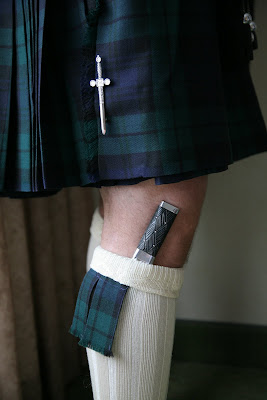 Scottish attire worn by groom for his wedding includes kilt and knife tucked into sock
