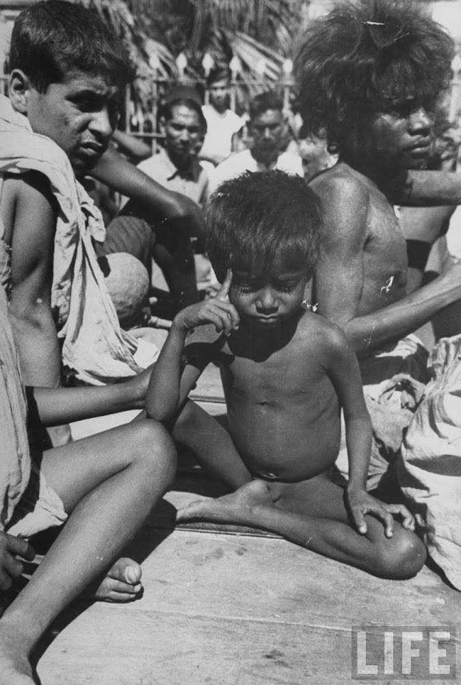 Starving families sitting in the hot scortching sun