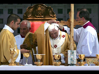Pope Benedict XVI is adjusting  his skullcap at Manger Square outside the Church of the Nativity in Bethlehem celebration event pic
