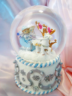 Beautiful white and skyblue Christmas snow globe and boy riding horse photo