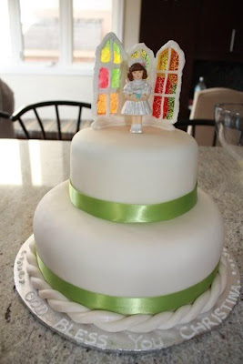 White cake with first communion and stained glass toppers