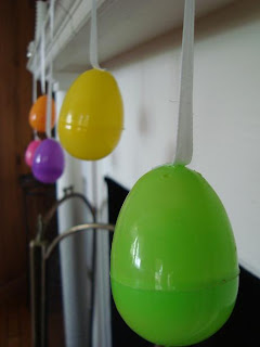 Plastic Easter eggs hanging from ribbons