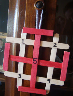 Jeruselam cross craft on a door knowb with numbers 1 through 5