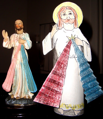 Paper standee of Jesue with the rays of the Divine Mercy next to Divine Mercy statue