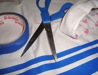 White and blue veil with scissors, baby headband, and painter's tape