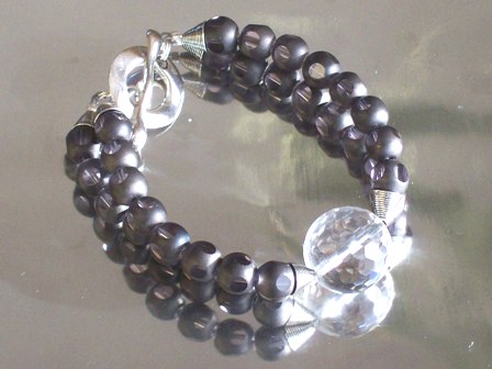 Faceted quartz bead centered amongst grey polka dot glass beads, bracelet - $54