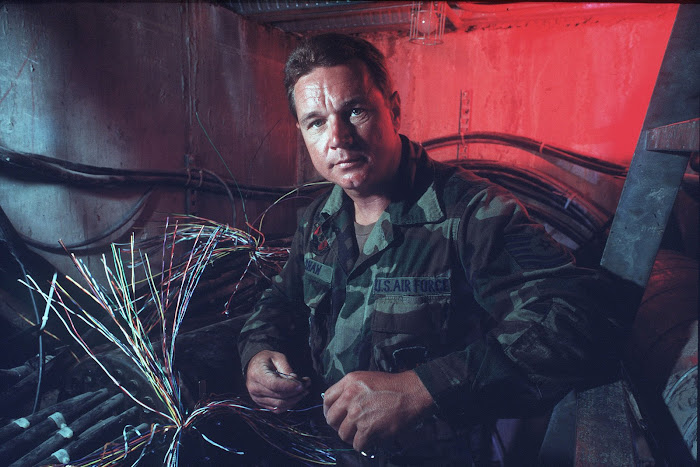 TSgt Edward Shaw in underground cable vault.