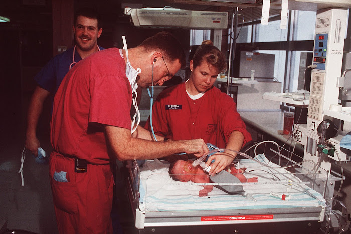 Maj. (Dr.) Mark Bertagnoli examines a 16 week premature baby