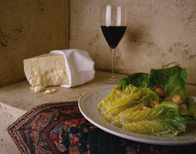 Serene Picture of a Glass of Red Wine and Salad in an Italian setting