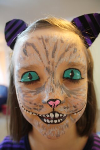 in all honesty face  painting  the Cheshire Cat 