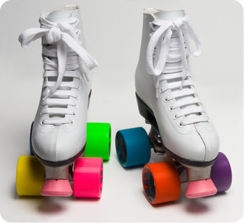 white roller skates with rainbow wheels