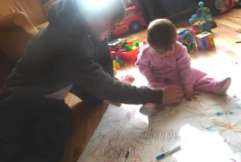 Korey drawing with Savannah - who loves to have her hand traced