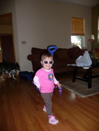 Practicing for a catwalk...she's so Hollywood with her glasses!