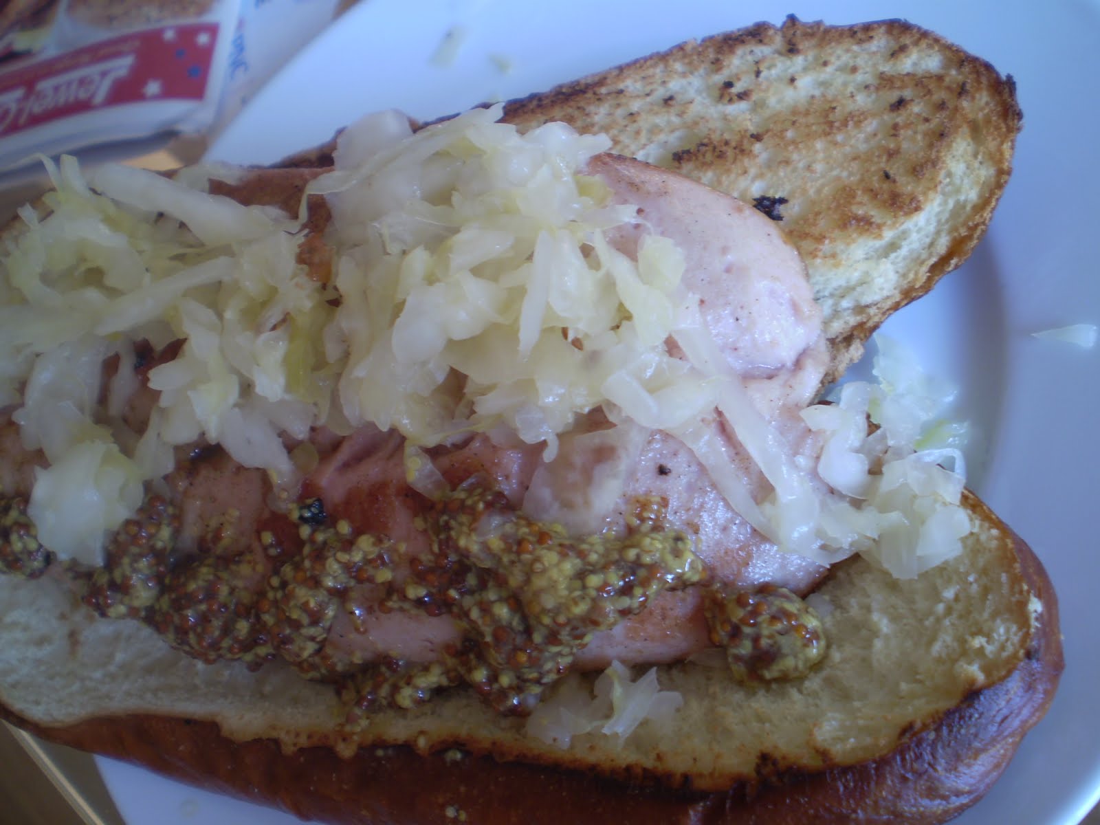 KING BOLETUS Pork and veal hot dog on a pretzel roll with sauerkraut