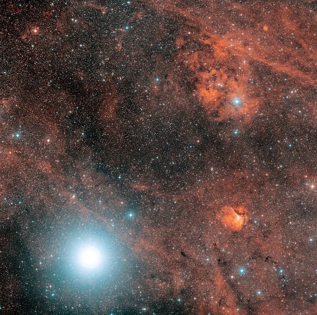 Deneb, one of the most luminous stars, in a colorful neighborhood