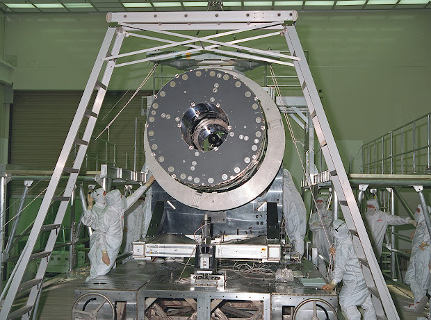 CXO's High Resolution Mirror Assembly (HRMA) being removed from the test structure in the X-Ray Calibration Facility (XRCF) at the Marshall Space Flight Center (MSFC).