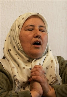 Bosnian Muslim Fadila Efendic, 56, of Srebrenica, reacts during a live TV broadcast from the World Court decision in The Hague, at her the home in the village of Potocari near Srebrenica, Bosnia 120 kilometers (75 miles) northeast of Sarajevo, Monday, Feb. 26, 2007.