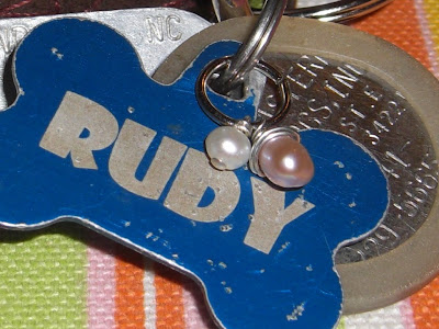 Up close picture of the charm attached with Rudy's ID tag