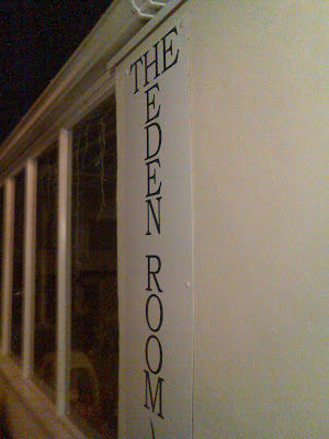 A sign for 'The Eden Room', with 'The' running across and 'Eden Room' underneath it running down