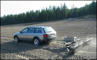 funny plough photo of car doing the job of a tractor weird but it works
