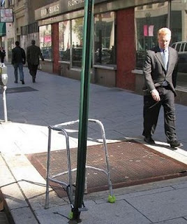 funny picture of walking frame chained up to a post to stop it being stolen