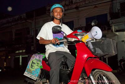 CamboFest staffer Narith Hoo riding a moto fitted with a loudspeaker to promote the festival