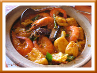 A clay pot of curry prawn with others