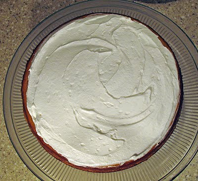 An overhead photo of a pumpkin cheesecake with rum whipped topping.