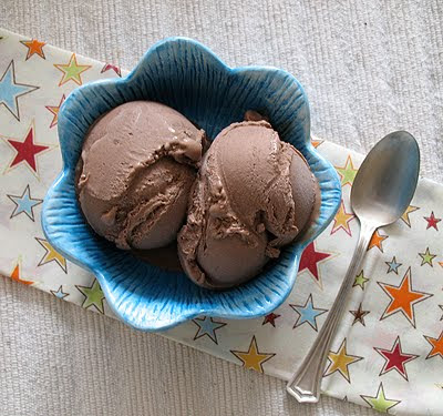 Mexican chocolate ice cream in a blue bowl with a spoon on the side.