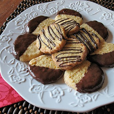 A picture of toasted coconut orange icebox cookies on a white decorative plate.