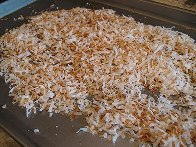 A close up photo of toasted sweetened flaked coconut.