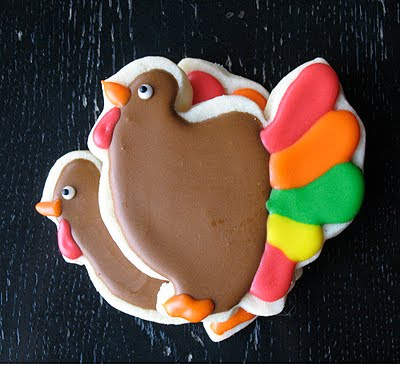 A close up photo of two thanksgiving turkey cookies.