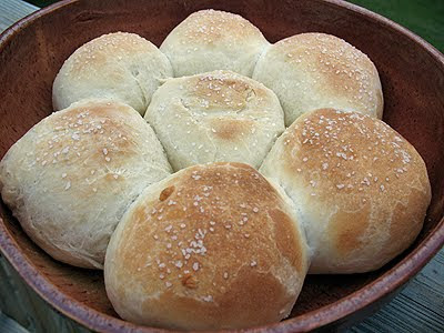 A close up photo of homemade dinner rolls in a cast iron skillet.