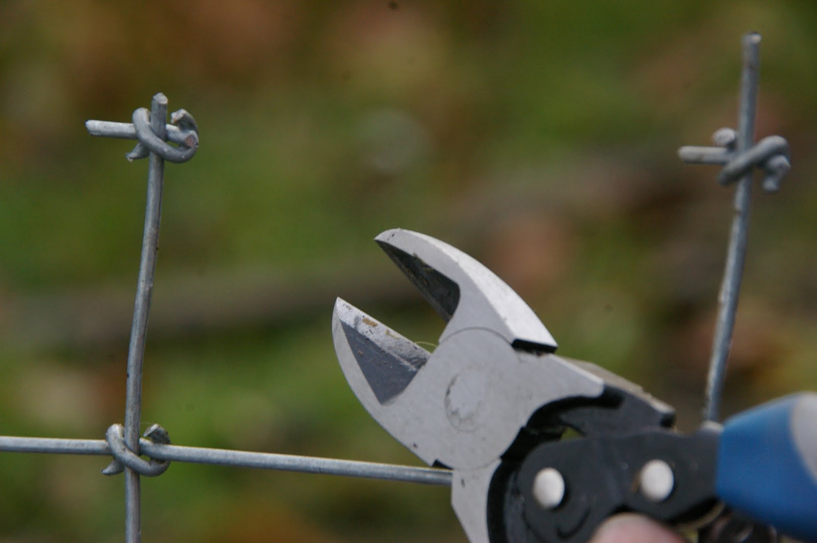 meat Stretching fencing with a tractor and a log