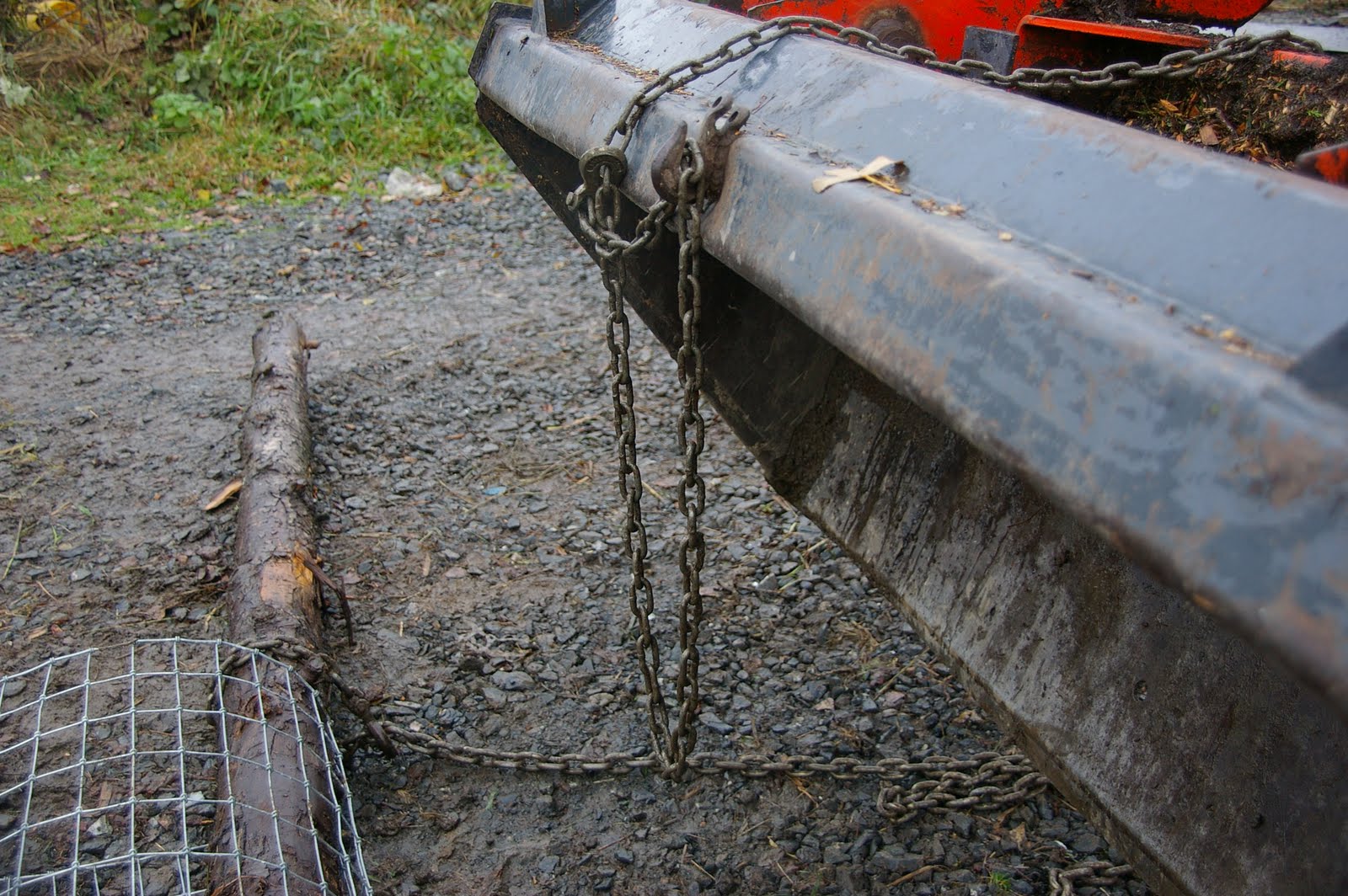 meat Stretching fencing with a tractor and a log