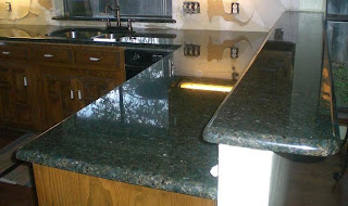 rustic / unpolished granite tiles, or tumbled marble or travertine roman tiles. Natural color or a very clear onyx will fit perfectly