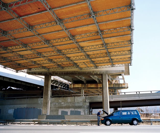 Man Under Overpass, New Jersey Turnpike, New Jersey by Amy Stein