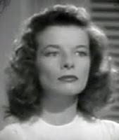 Head and shoulders of Katharine Hepburn, from The Philadelphia Story, looking severe and serious.