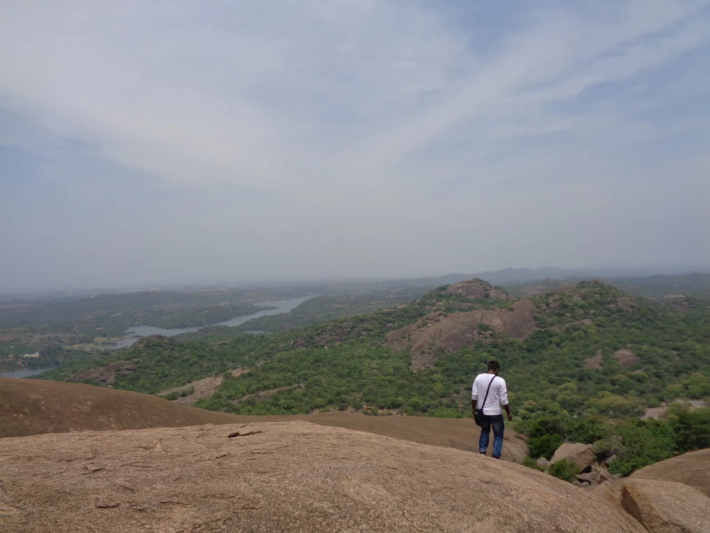 Savandurga Summit: Close-up of the ancient fort walls and ruins at the top of the monolithic hill.