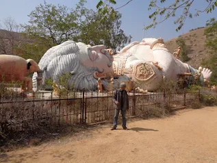 Large statue of Kumbhakarna, a figure from the Ramayana, resting on the ground